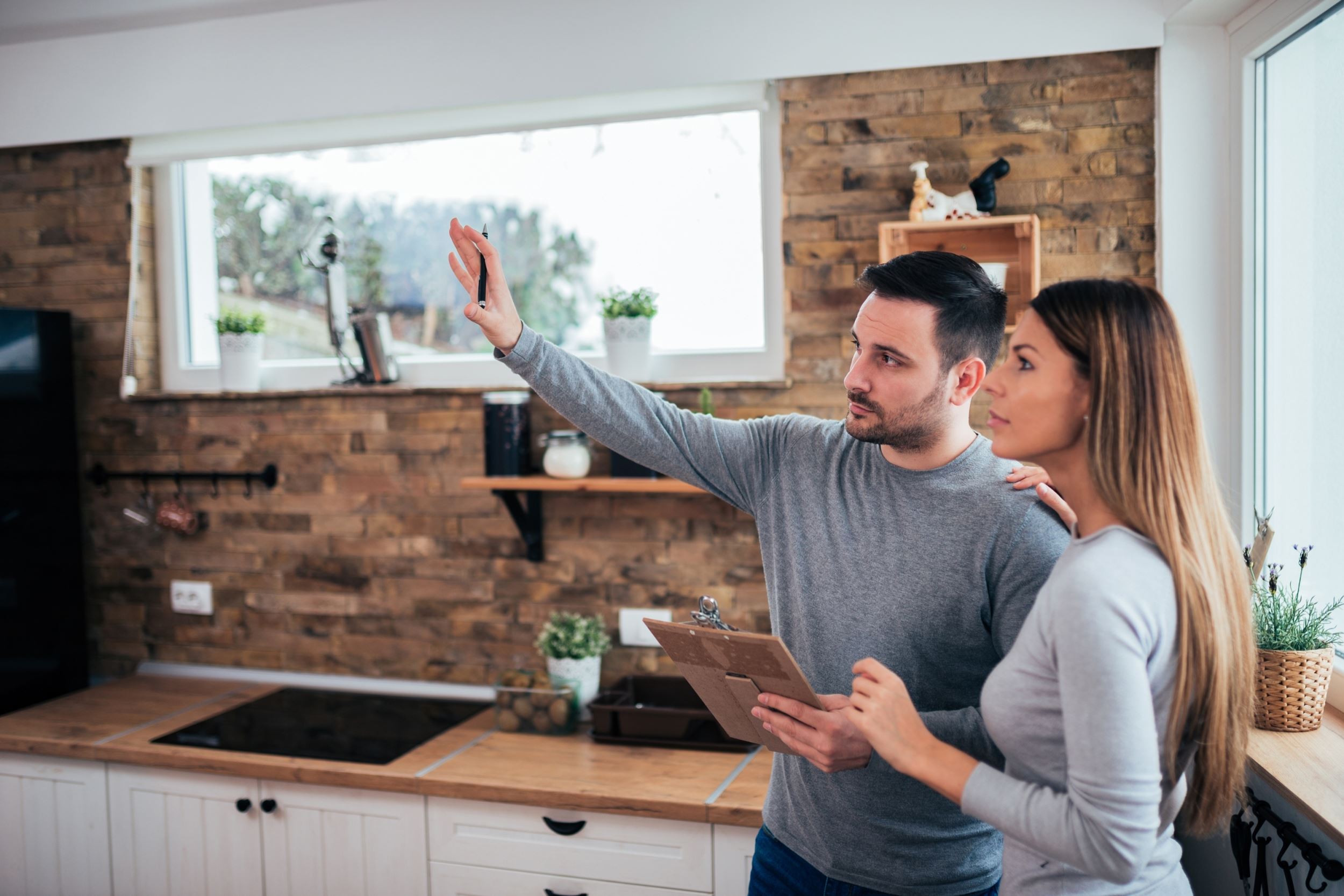 Couple in kitchen of house